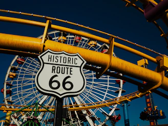 A close up of a street sign near a ferris wheel