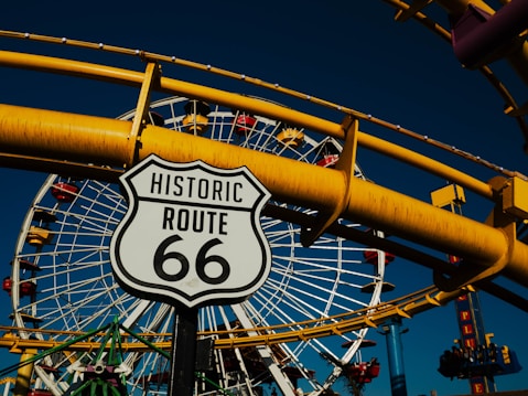 A close up of a street sign near a ferris wheel