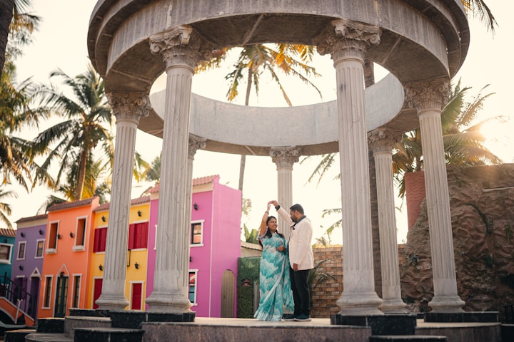 A man and woman standing in front of a gazebo