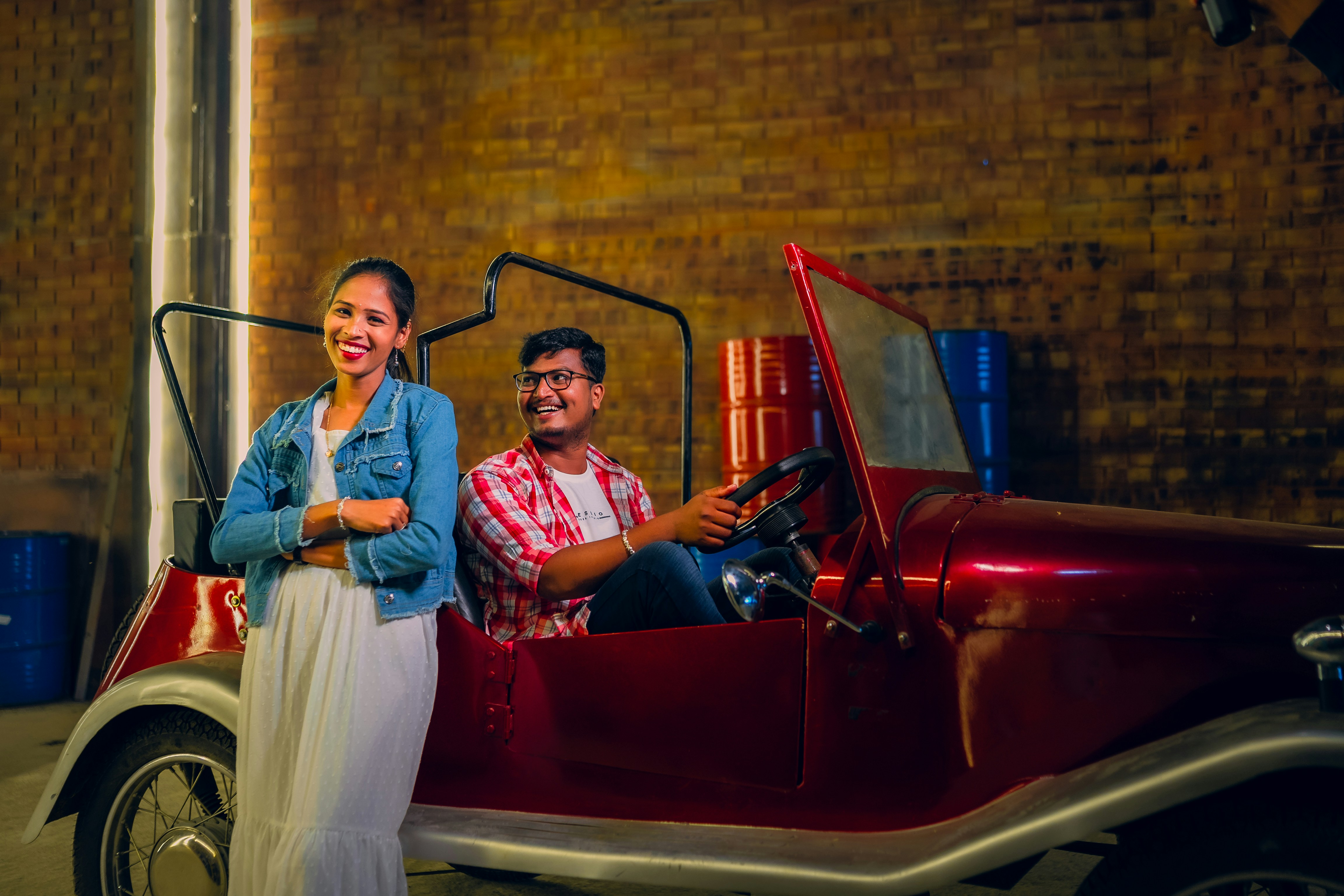 Customers reviewing paperwork while buying a used electric vehicle at a dealership