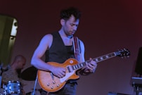 A man playing a guitar on a stage