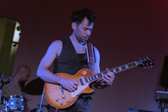 A man playing a guitar on a stage