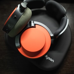 A pair of headphones sitting on top of a wooden table