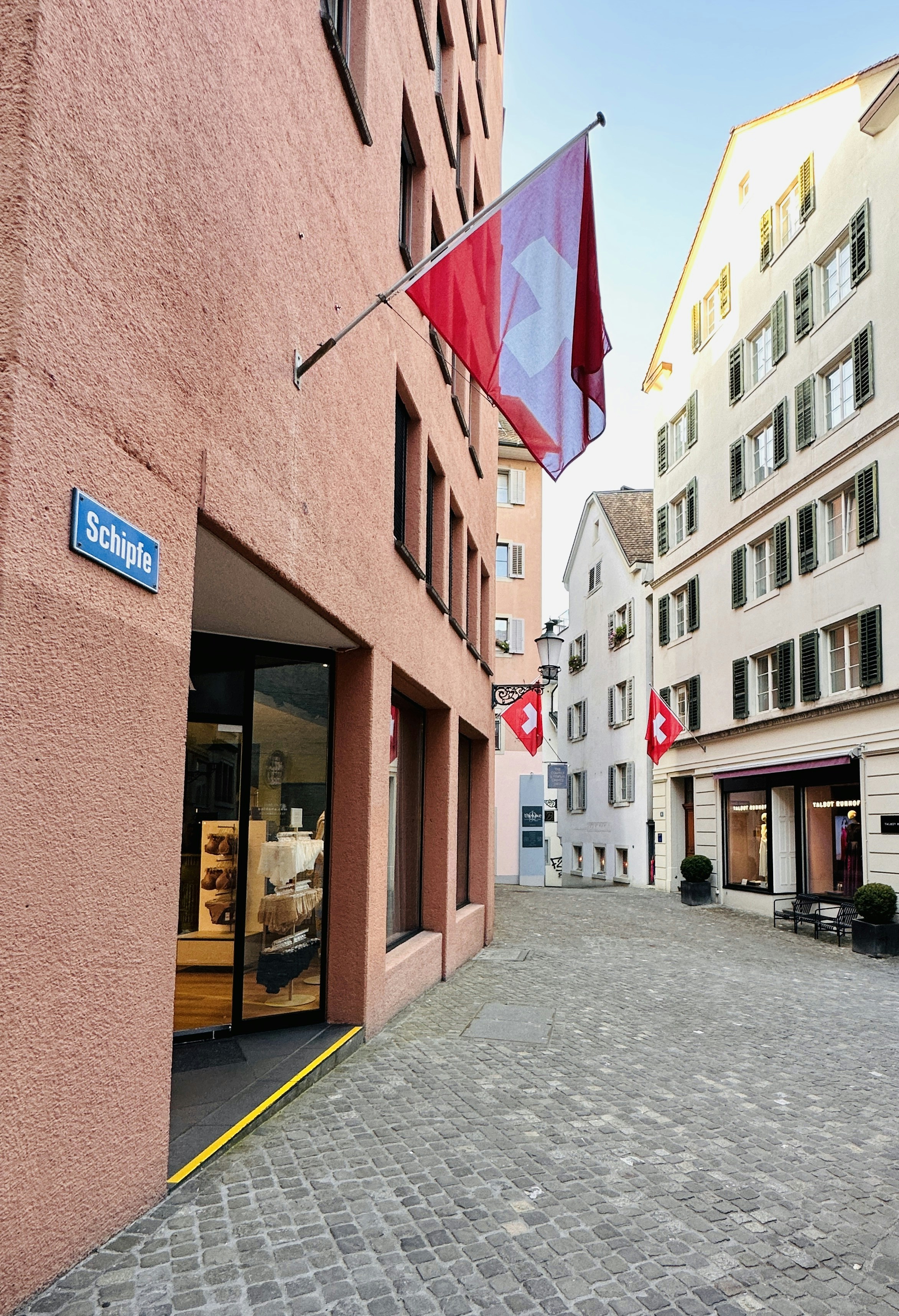 A red building with a blue sign on the front of it