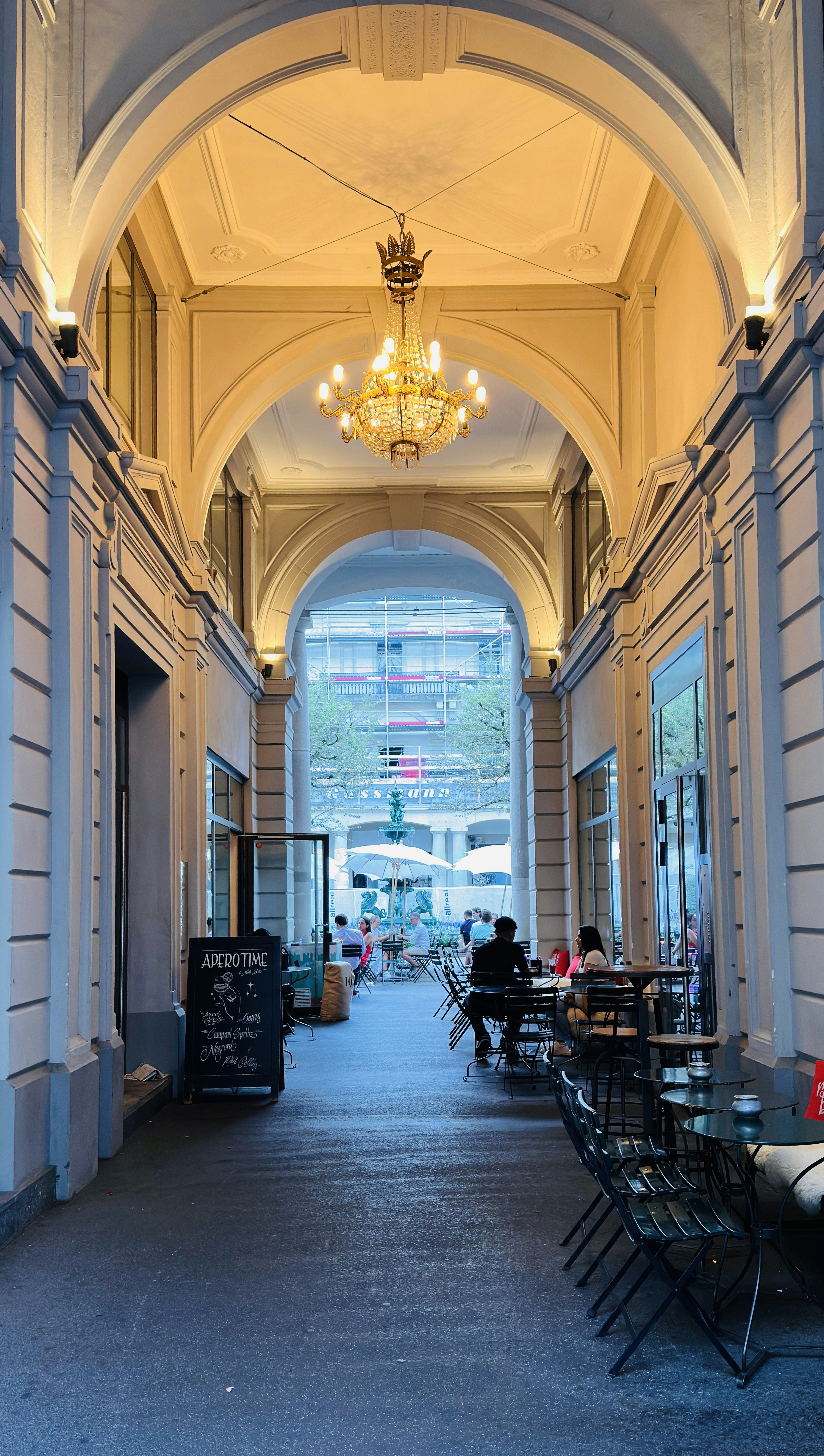 A long hallway with a chandelier hanging from the ceiling