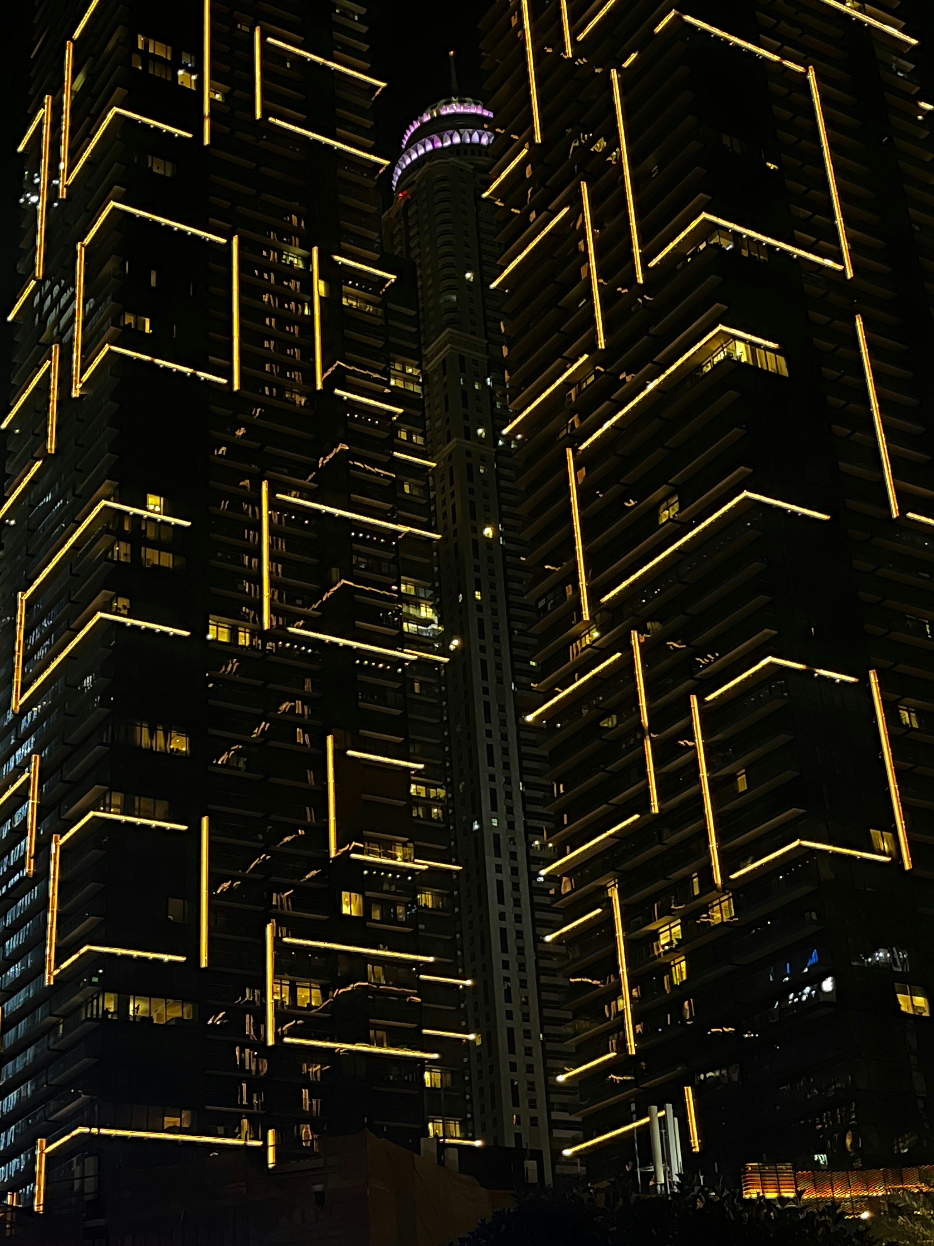 A very tall building lit up at night