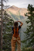 A man with a backpack standing on a mountain
