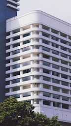 A tall white building sitting next to a tall blue building