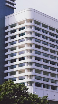 A tall white building sitting next to a tall blue building