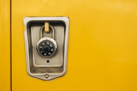 A close up of a lock on a yellow door
