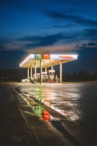 A gas station at night with the lights on