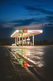 A gas station at night with the lights on