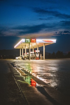 A gas station at night with the lights on