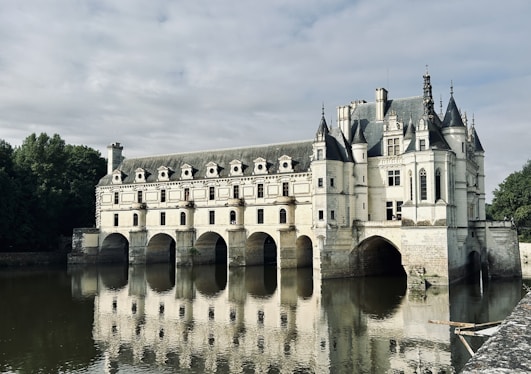 A castle is reflected in a body of water