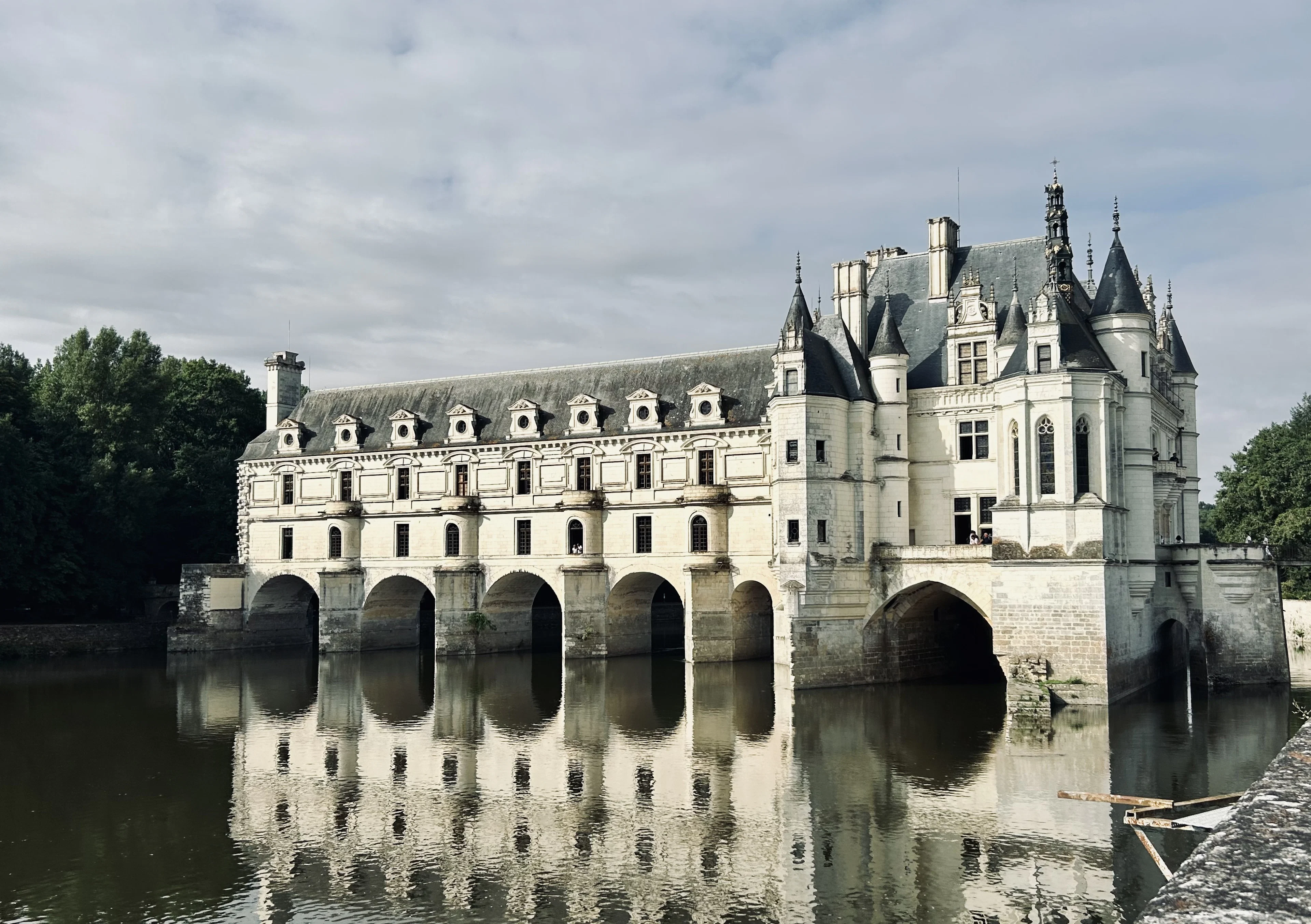 Château de Chenonceau's arched gallery spanning the River Cher, reflected in the water
