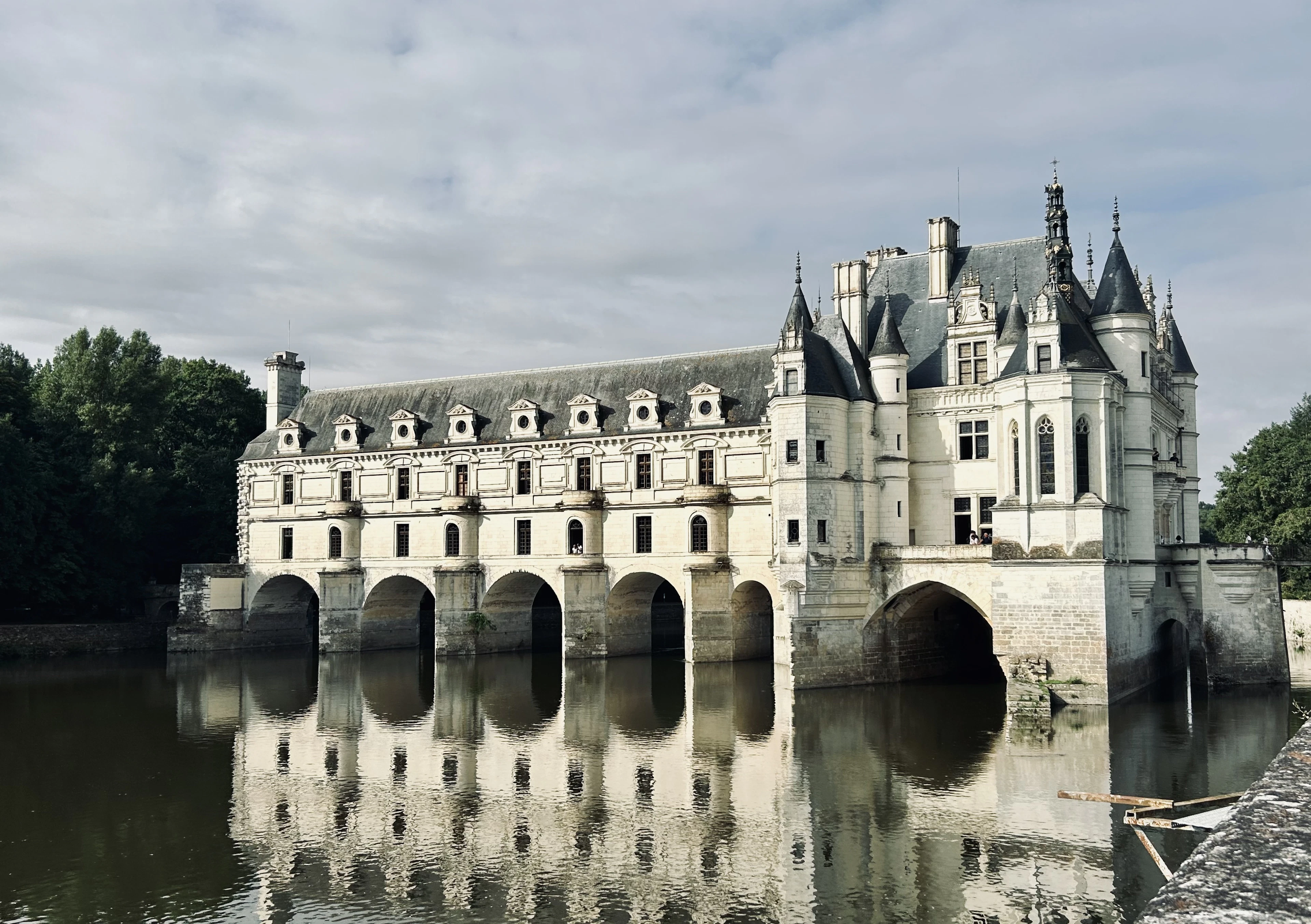 Château de Chenonceau's arched gallery spanning the River Cher, reflected in the water