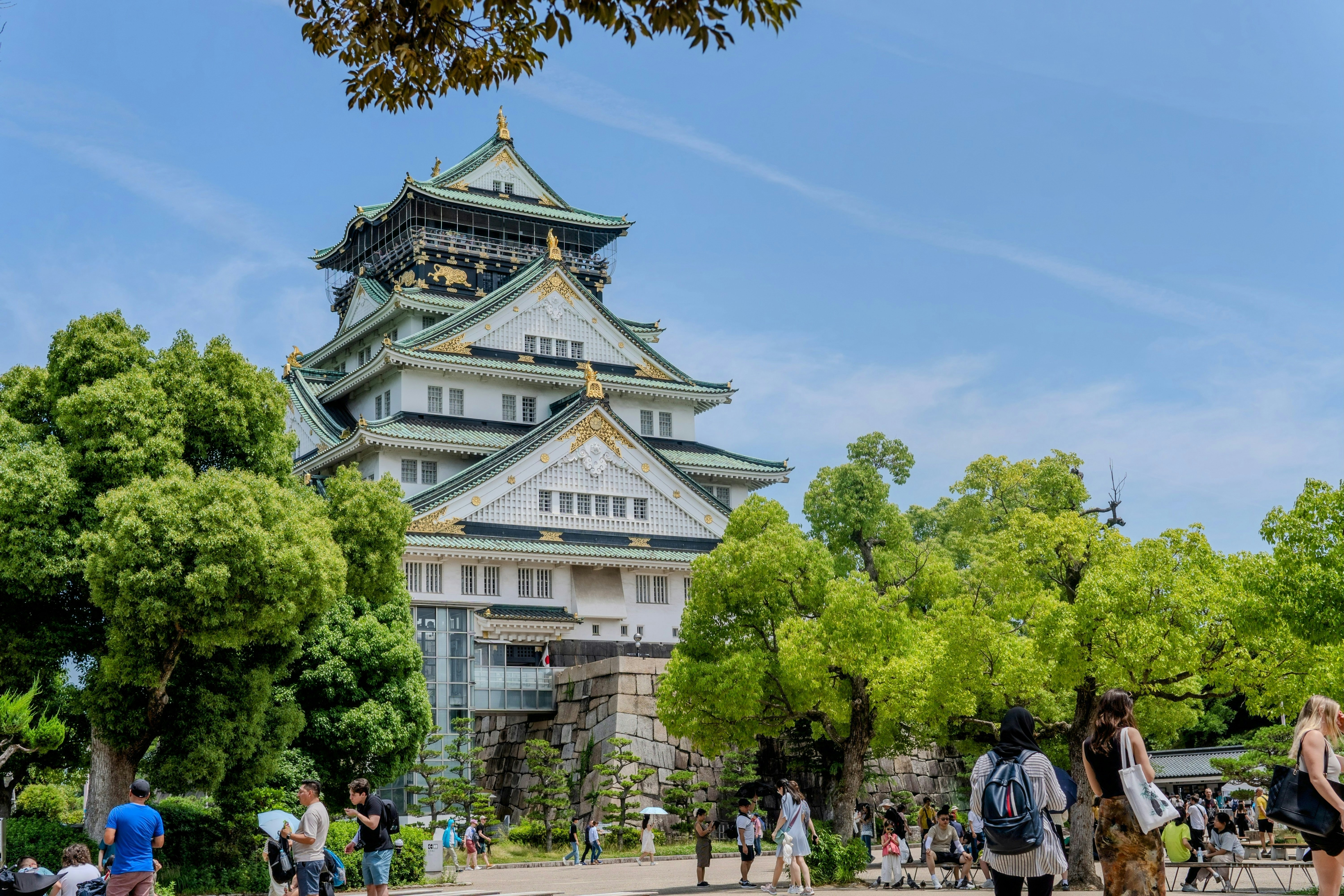 A group of people walking in front of a tall building