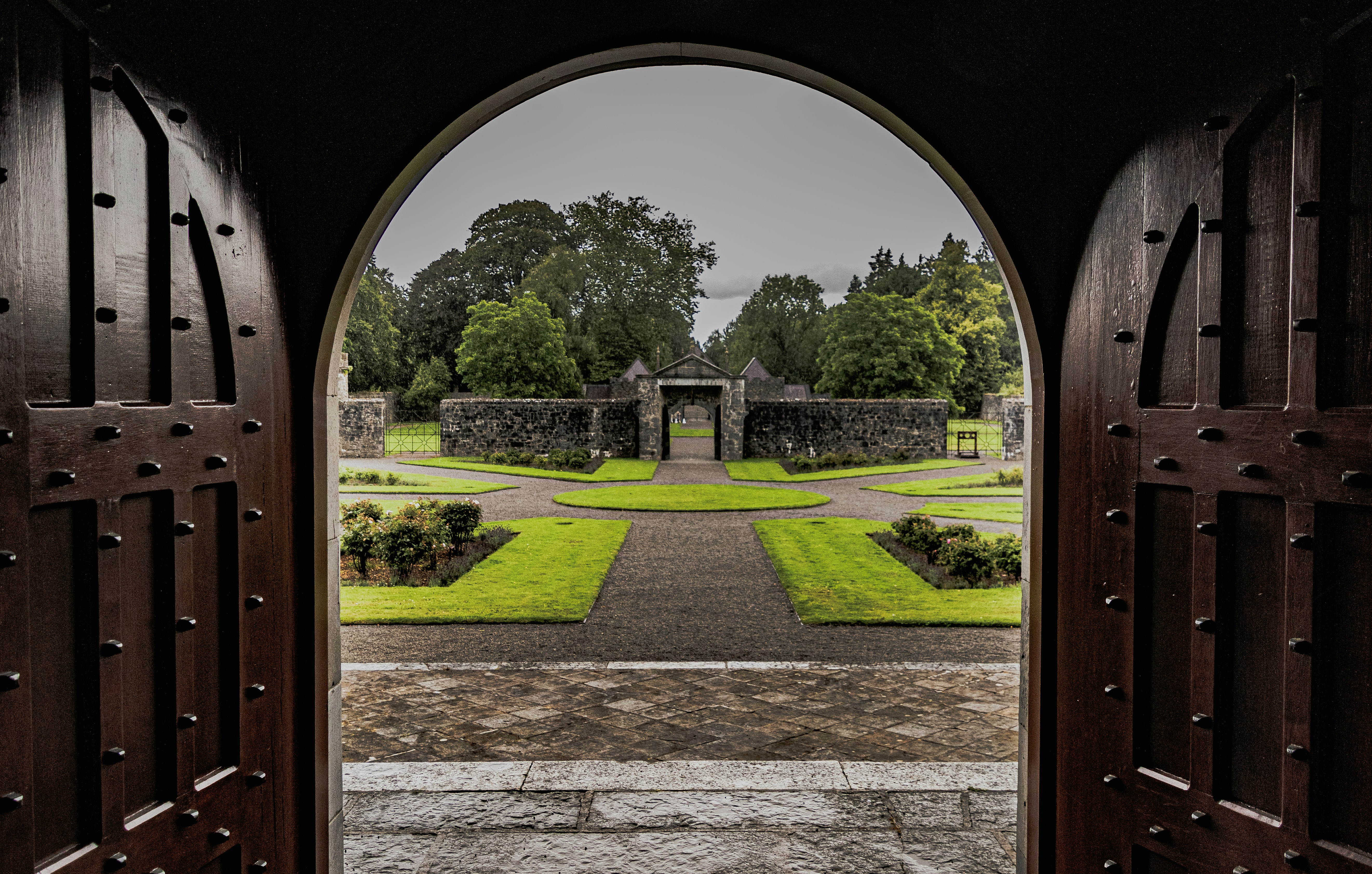An open door leading to a lush green park