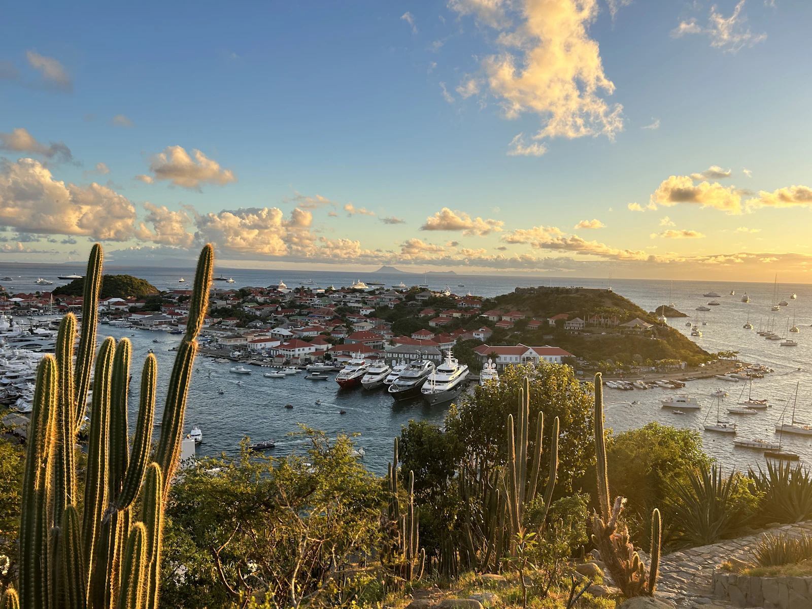 Gustavia harbour in St Barts at sunset, filled with yachts at anchor