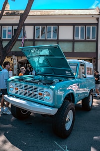 A blue truck parked in front of a building