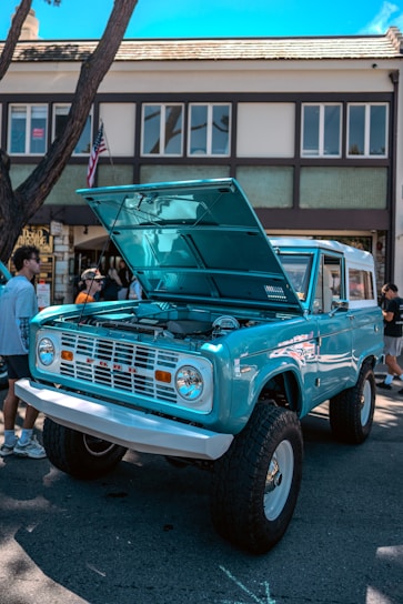 A blue truck parked in front of a building