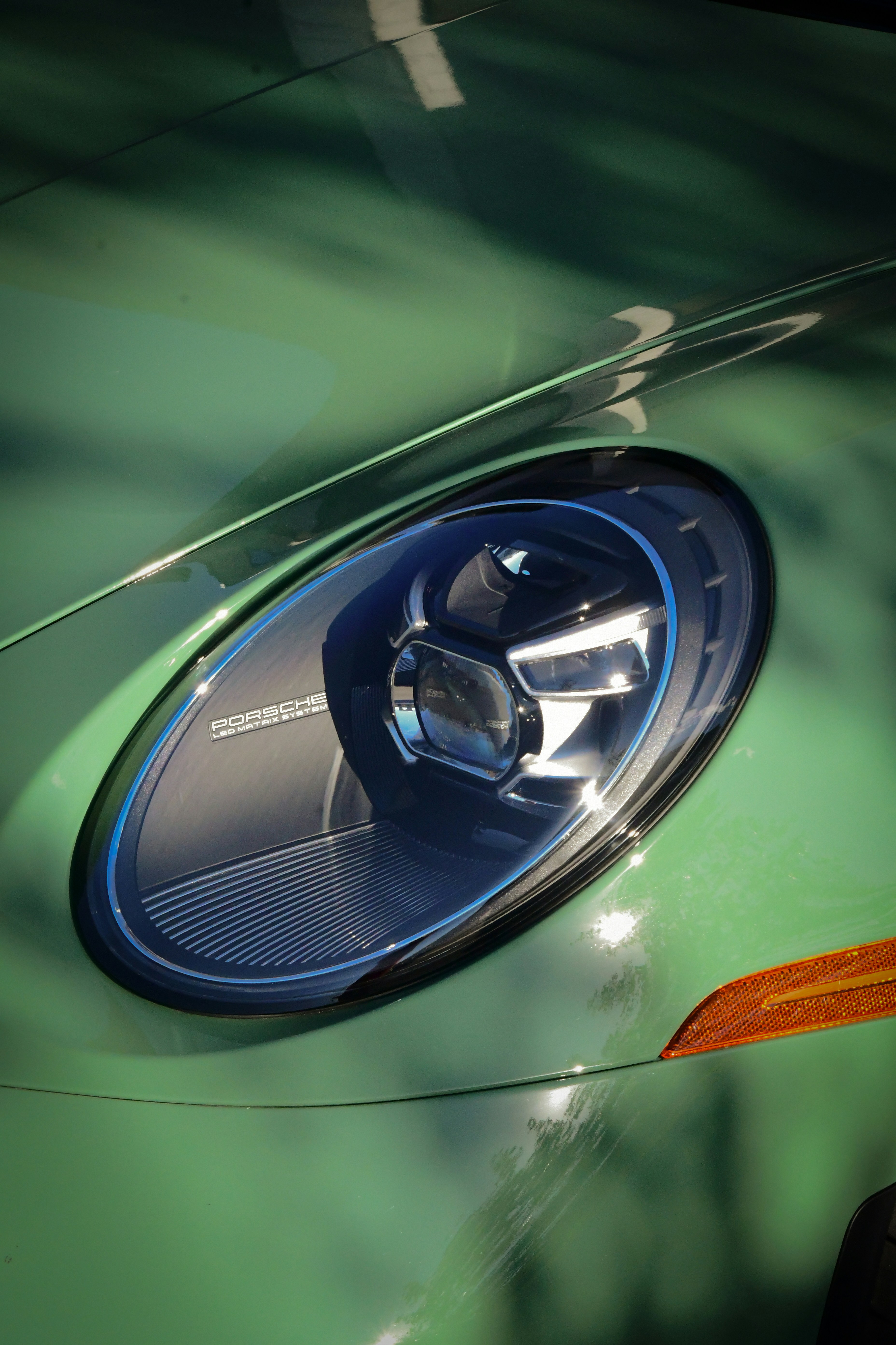 A close up of a green sports car door handle