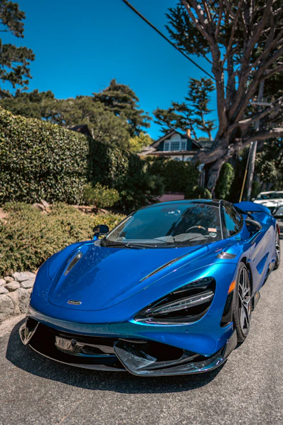 A blue sports car parked on the side of the road