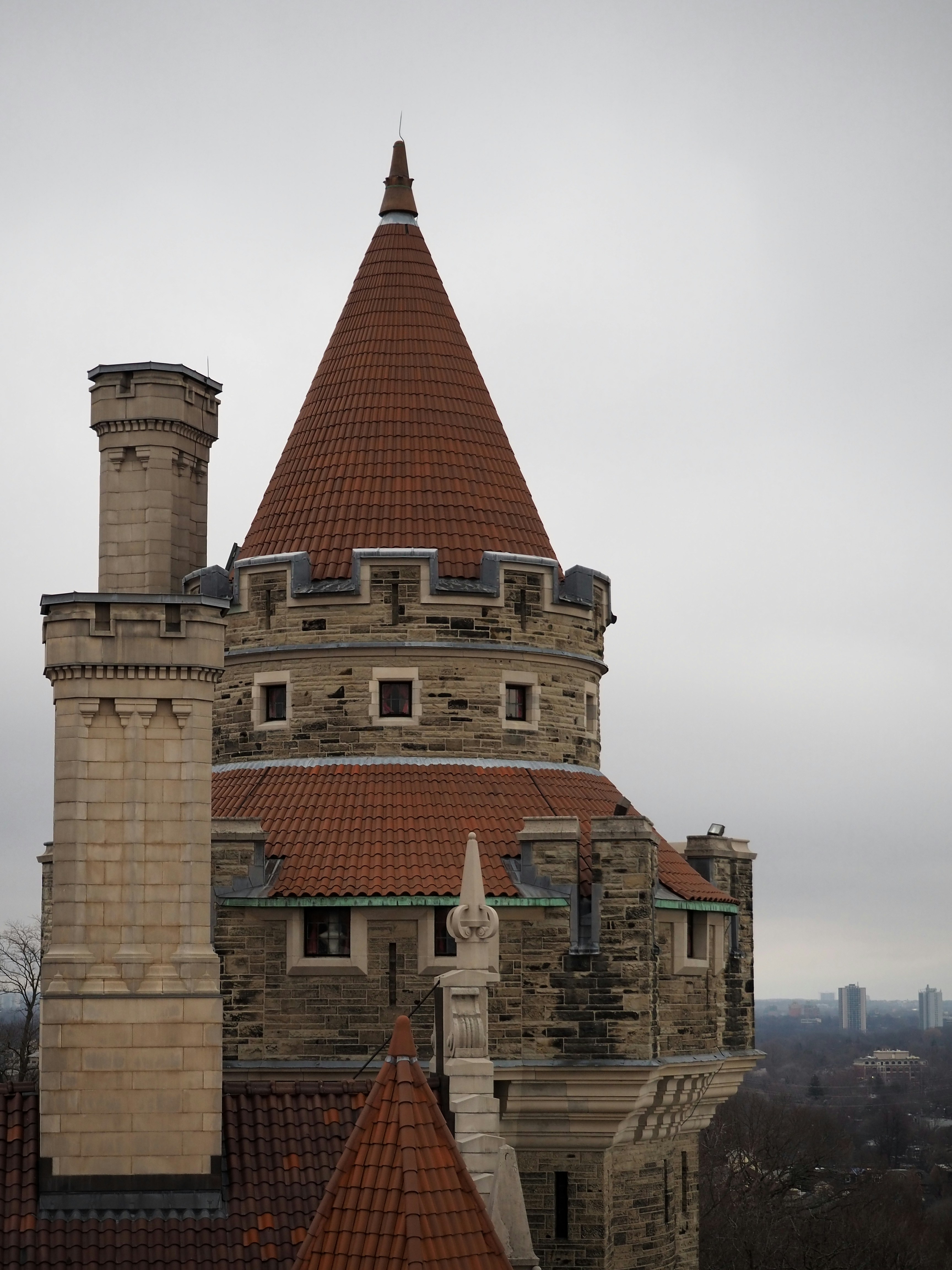 A tall building with a red roof and a tower