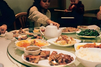 A group of people sitting around a table full of food