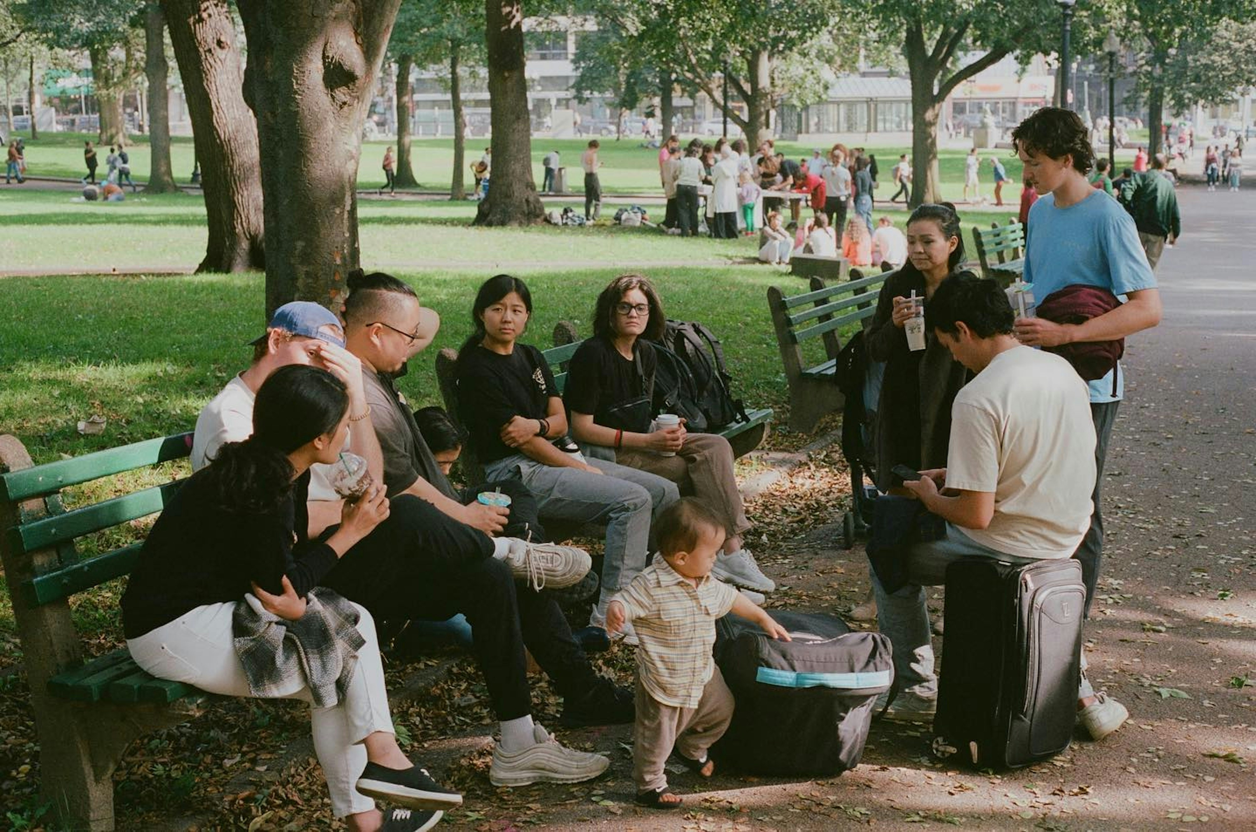 A group of people sitting on a park bench