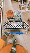 A person sitting on a shopping cart in a store