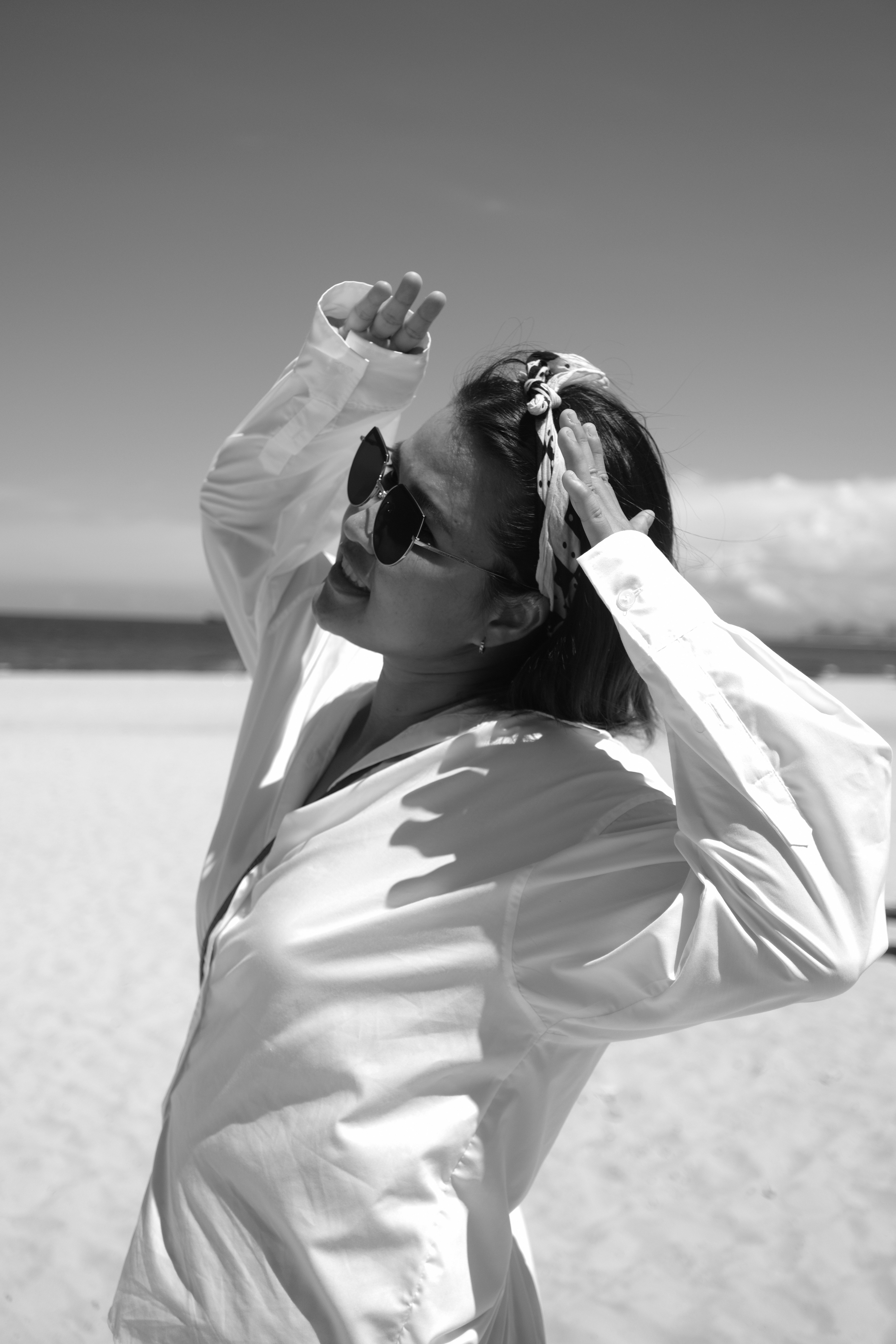 A woman standing on top of a sandy beach