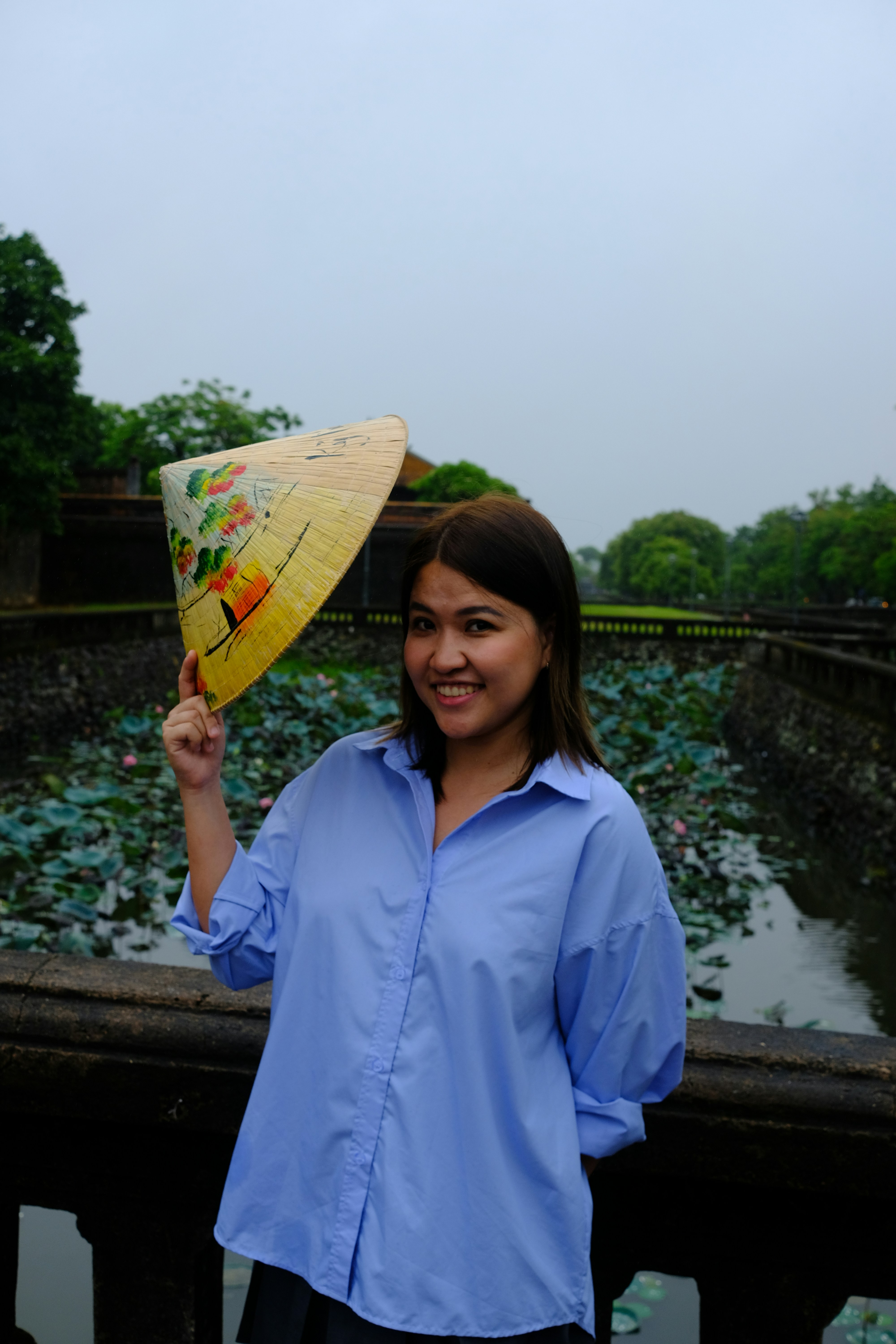 A woman is holding an umbrella over her head