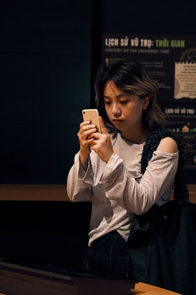 A woman is looking at her cell phone