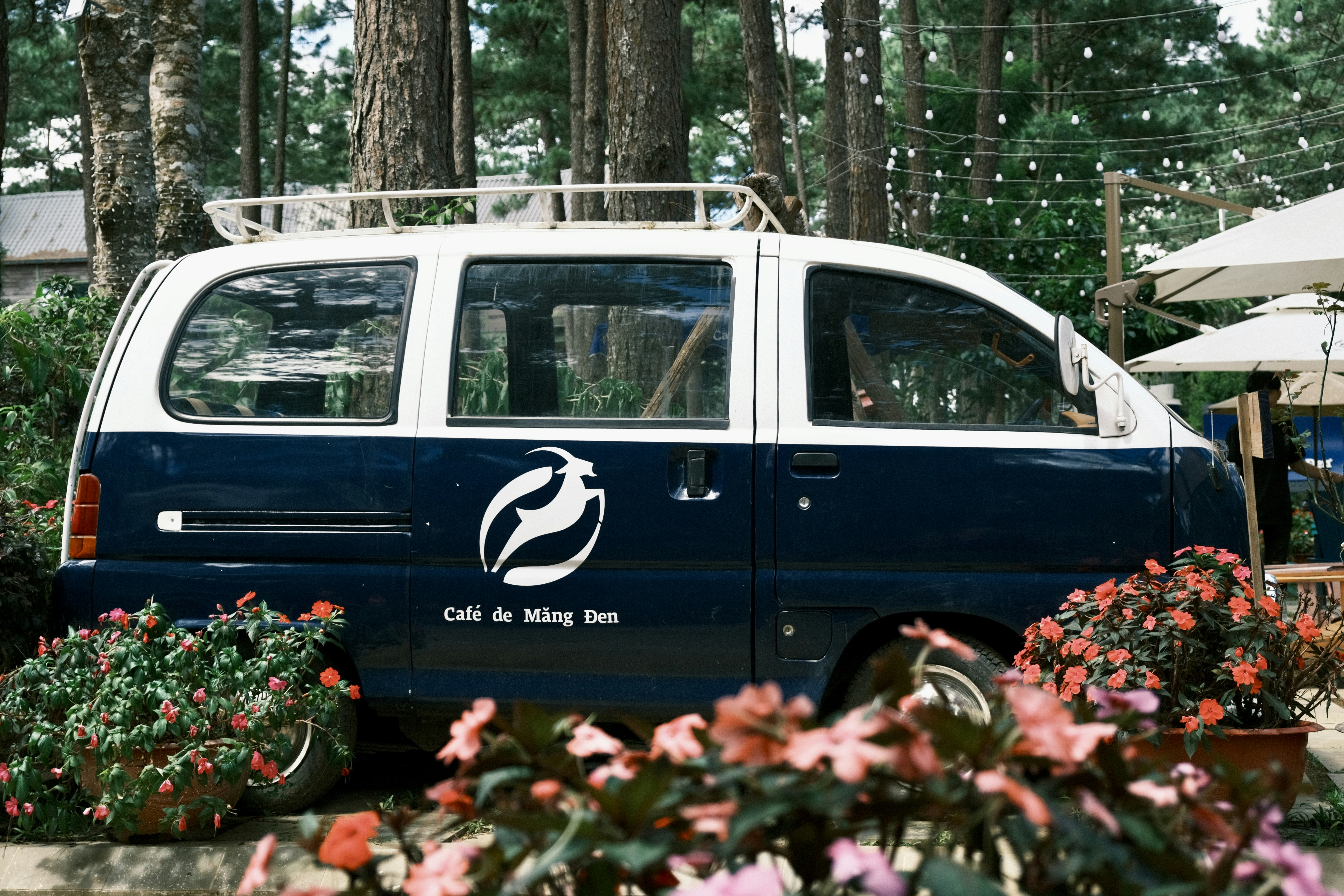 GMC-style electric pickup truck plugged into a DC fast charger at a modern station