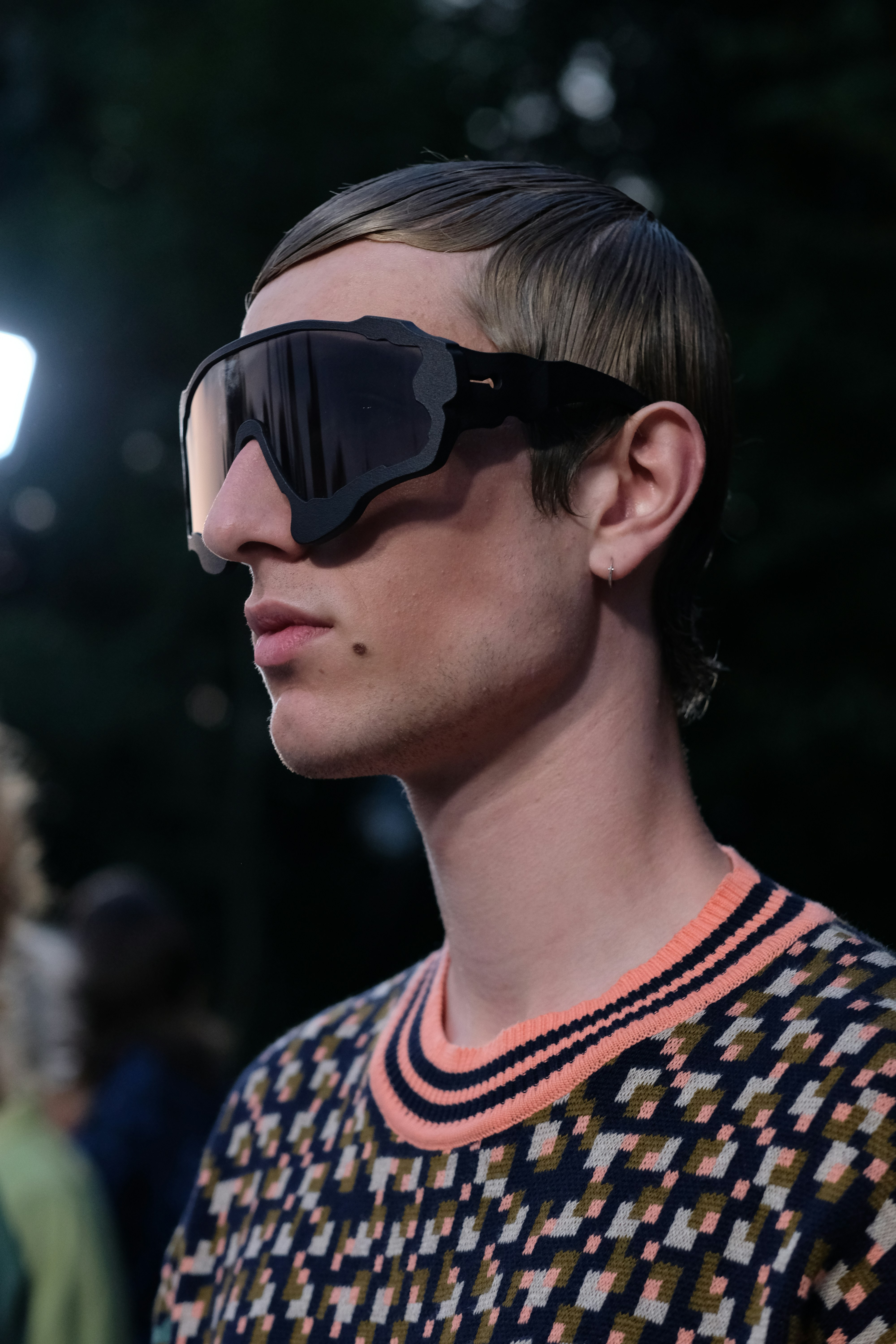 A man with a pair of sunglasses on his face