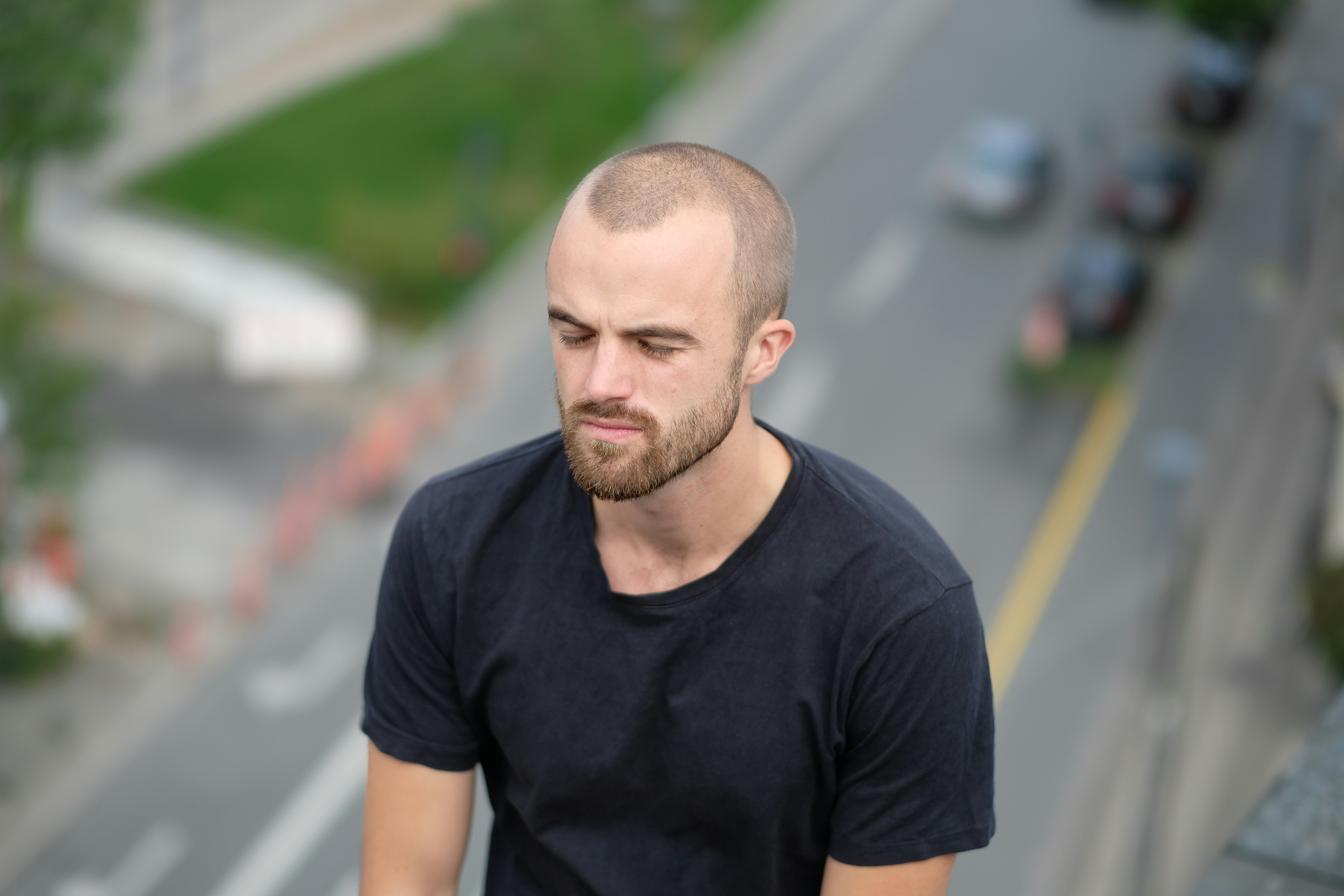 A man walking down a street with a skateboard