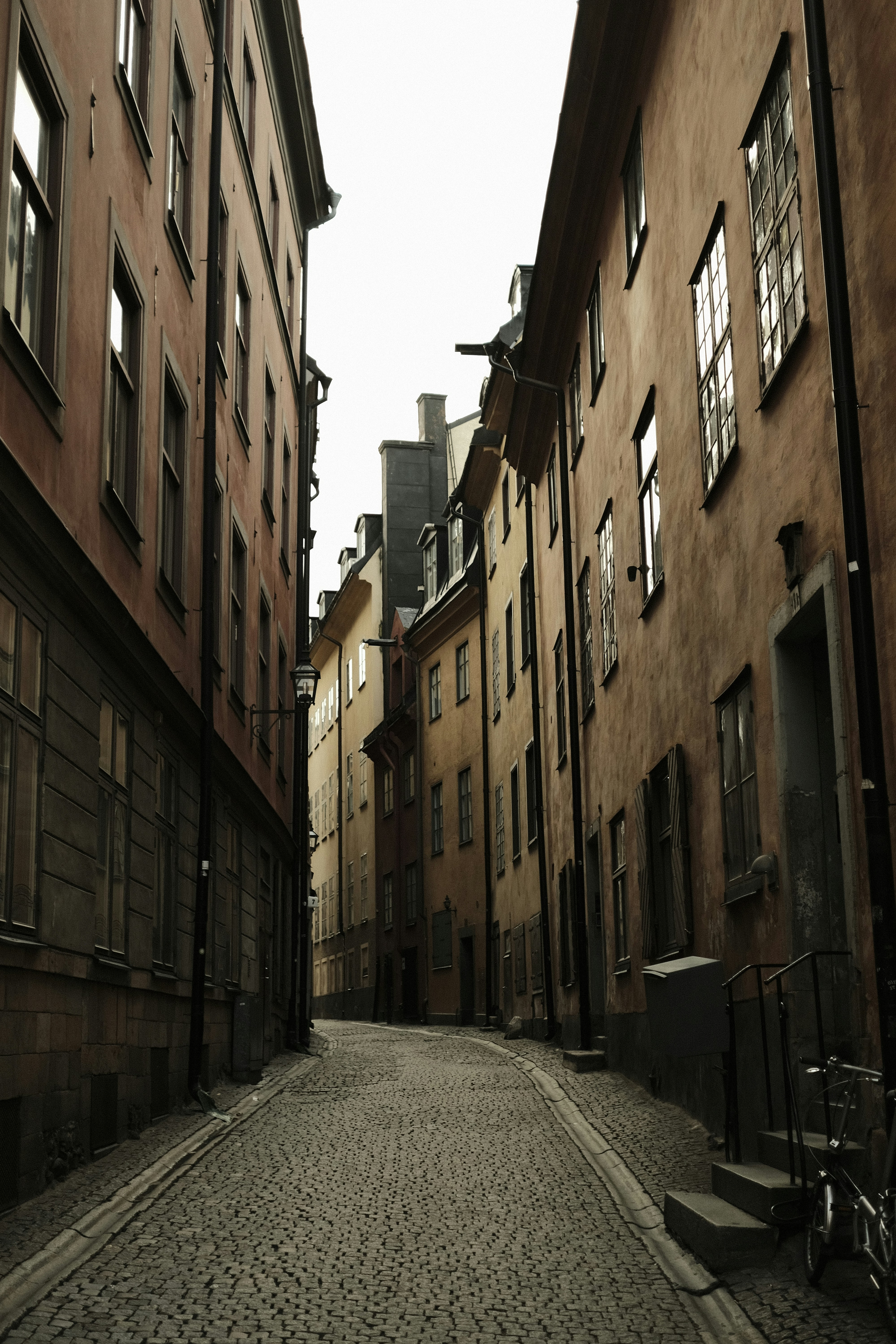 A cobblestone street lined with tall buildings