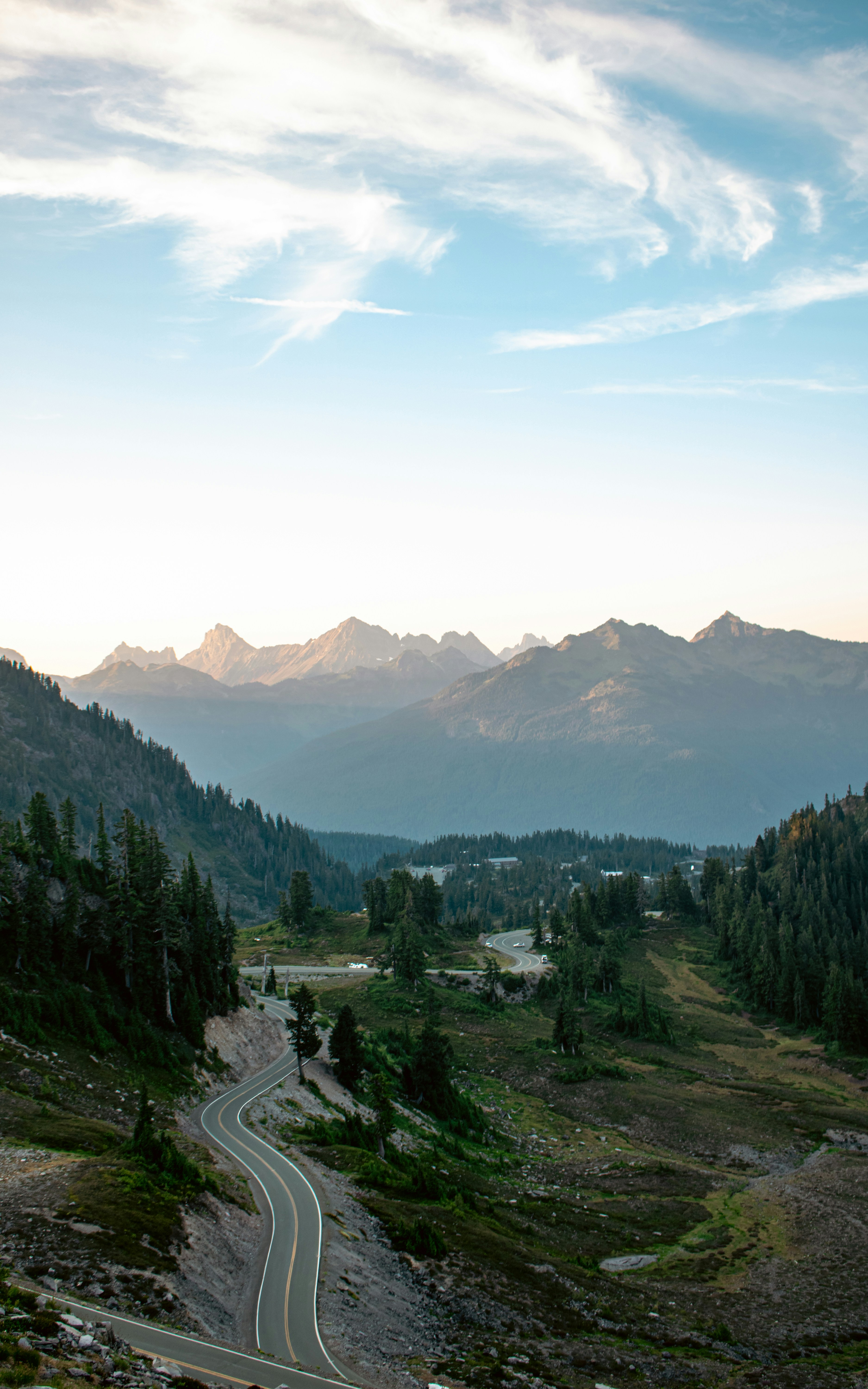 A scenic view of a road winding through the mountains photo – Free ...
