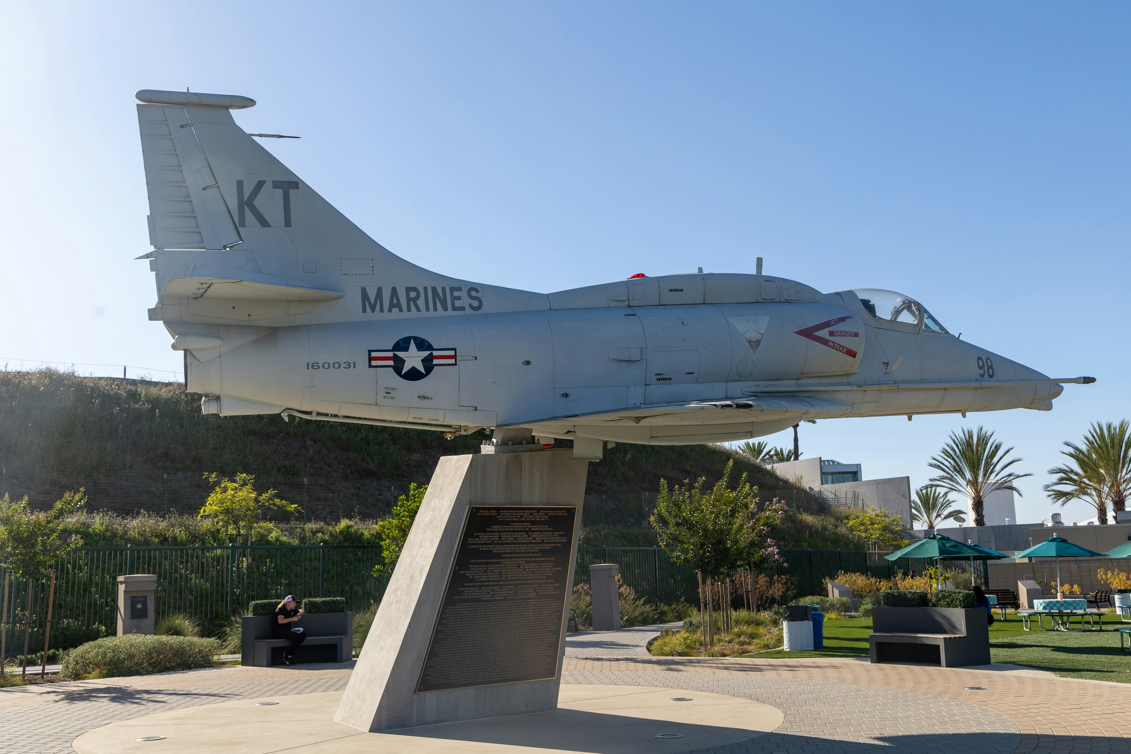 A fighter jet sitting on top of a cement slab