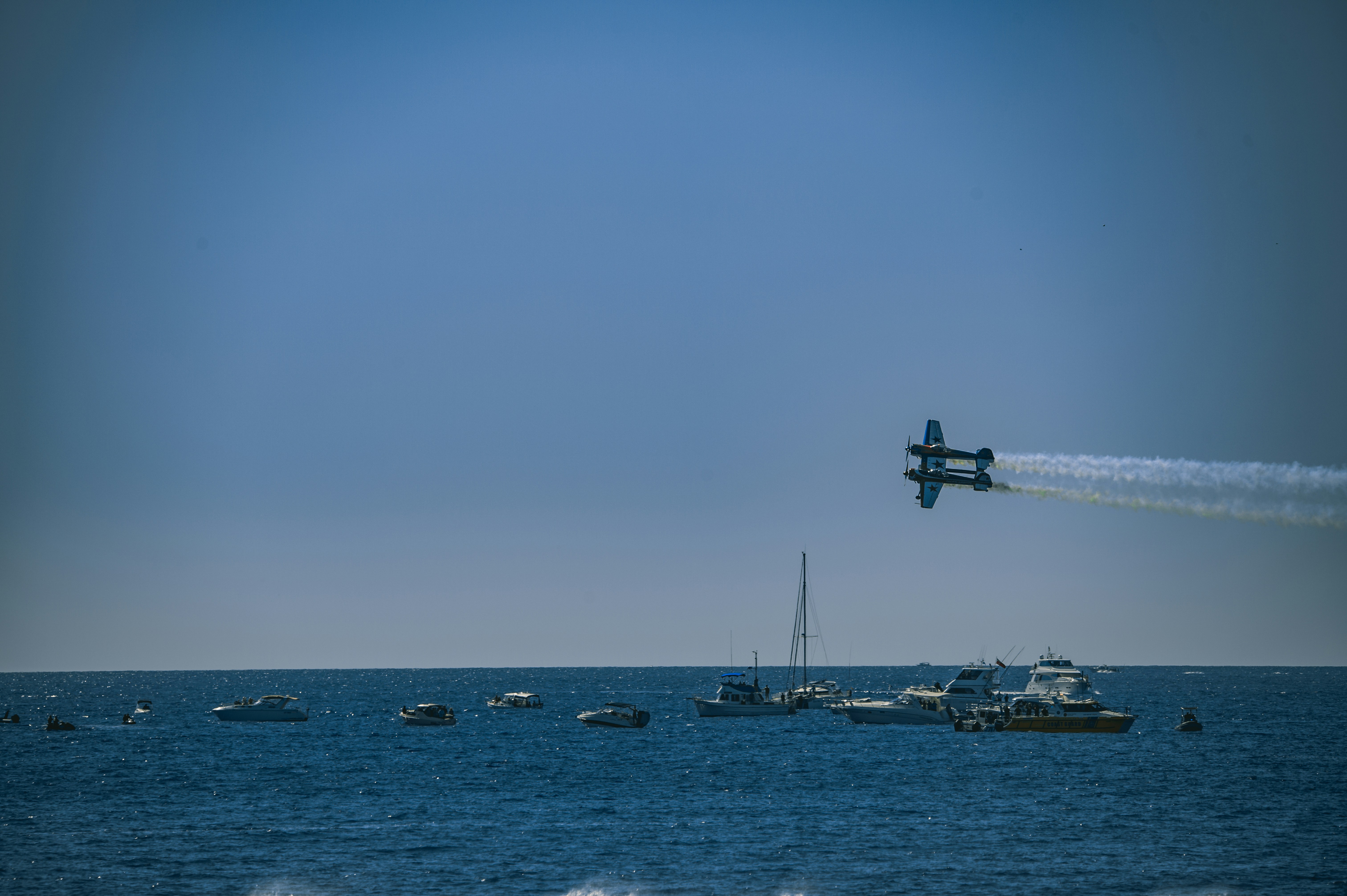 A plane flying over a body of water photo – Free Animal Image on Unsplash