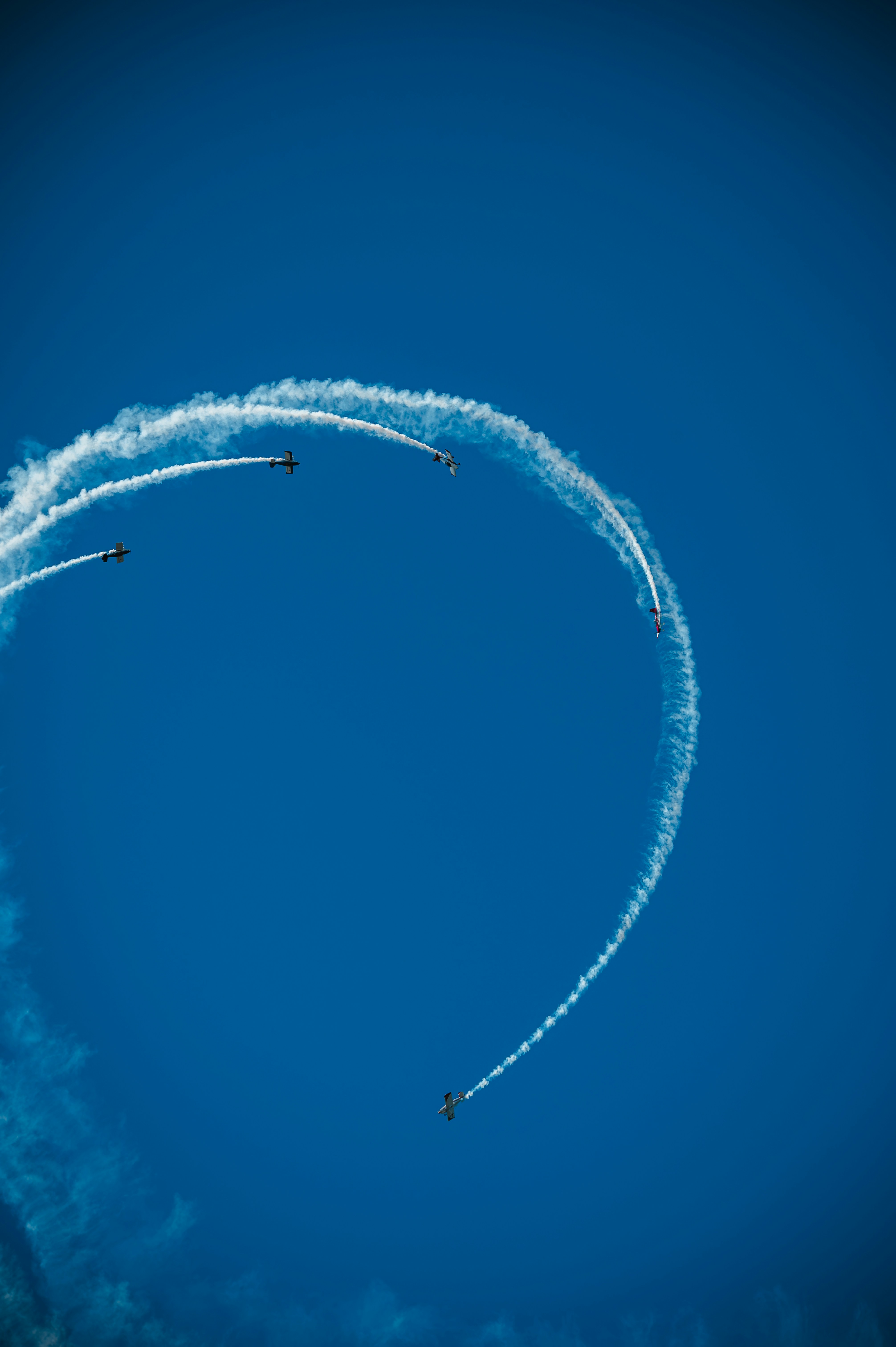 A group of jets flying through a blue sky
