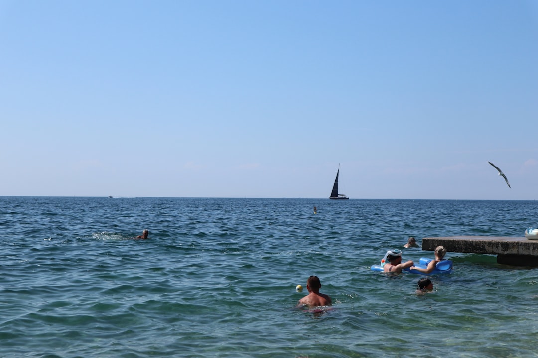A group of people swimming in the ocean,