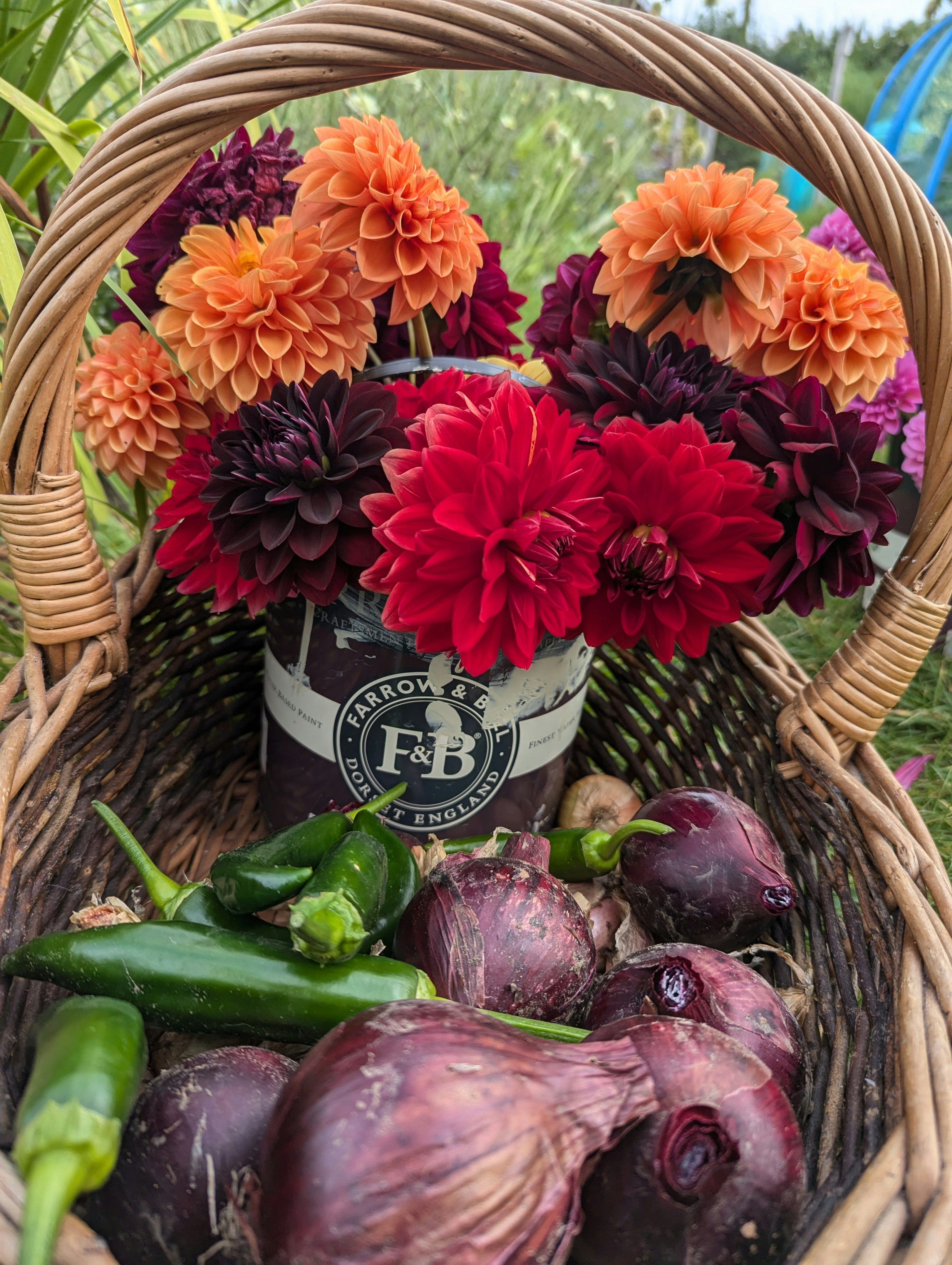 A basket filled with lots of different types of flowers