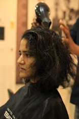 A woman getting her hair cut at a salon