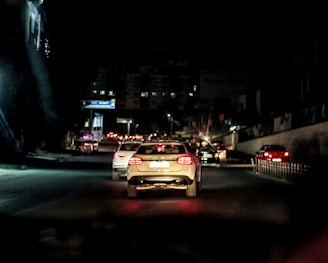 A car driving down a street at night