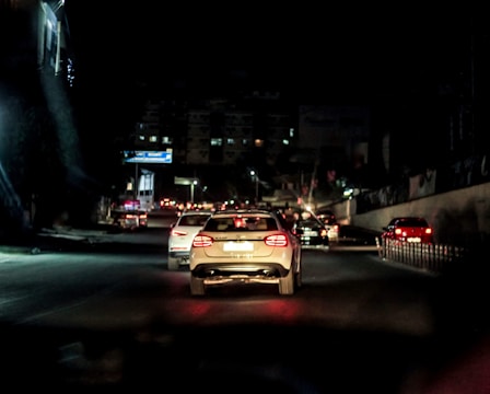 A car driving down a street at night