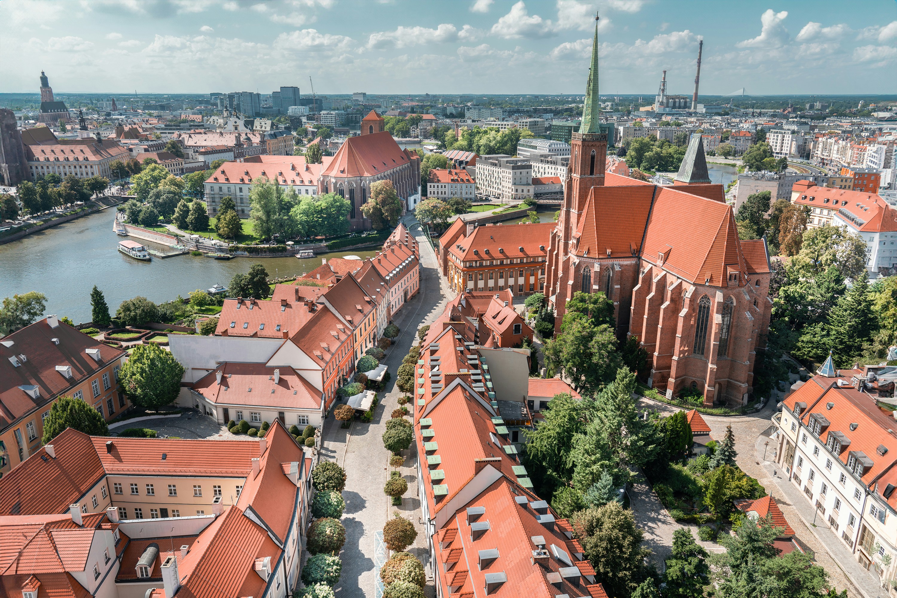 An aerial view of a city with a river running through it, European cityscape. City ​​buildings from above.