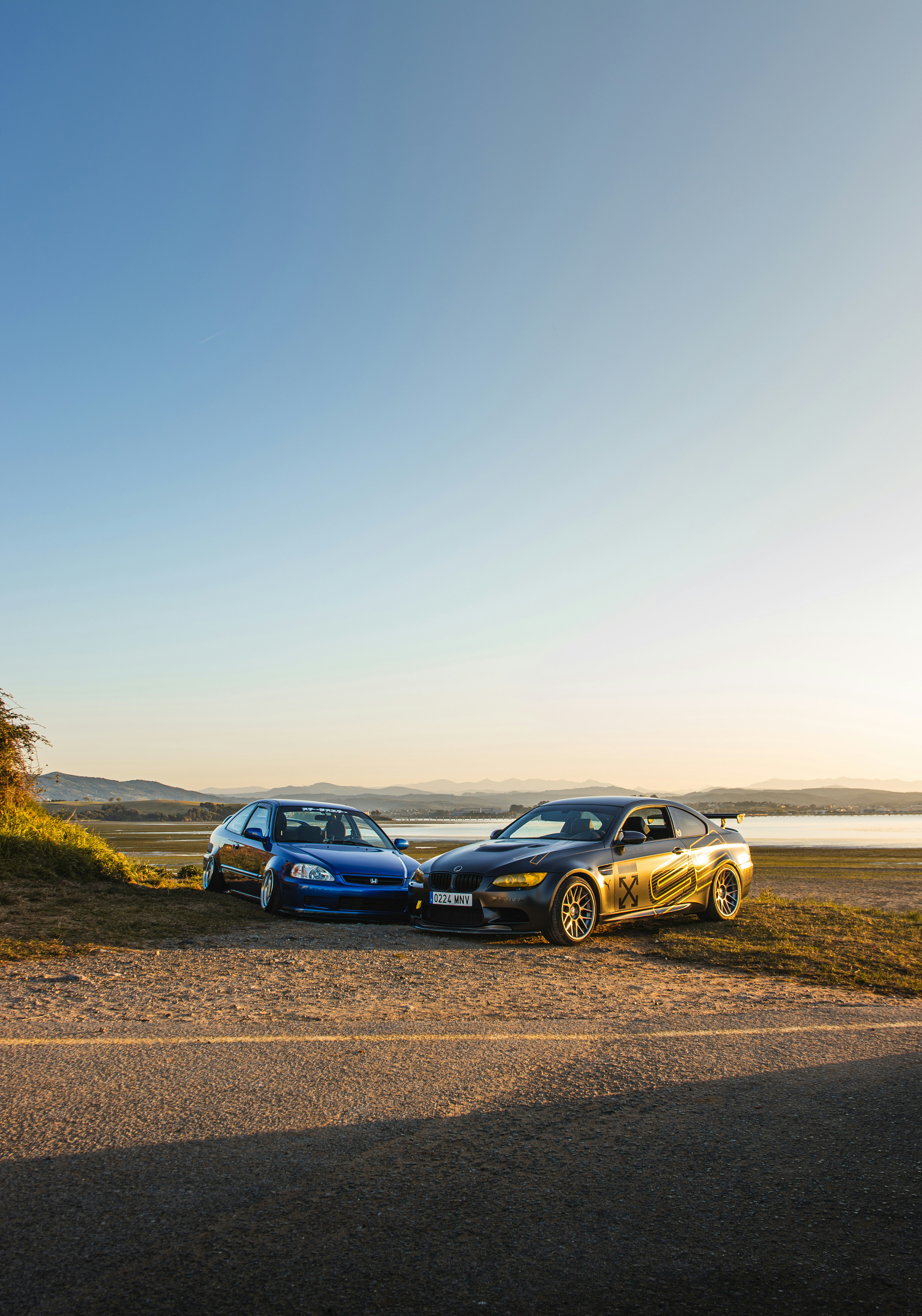 Two cars parked on the side of the road