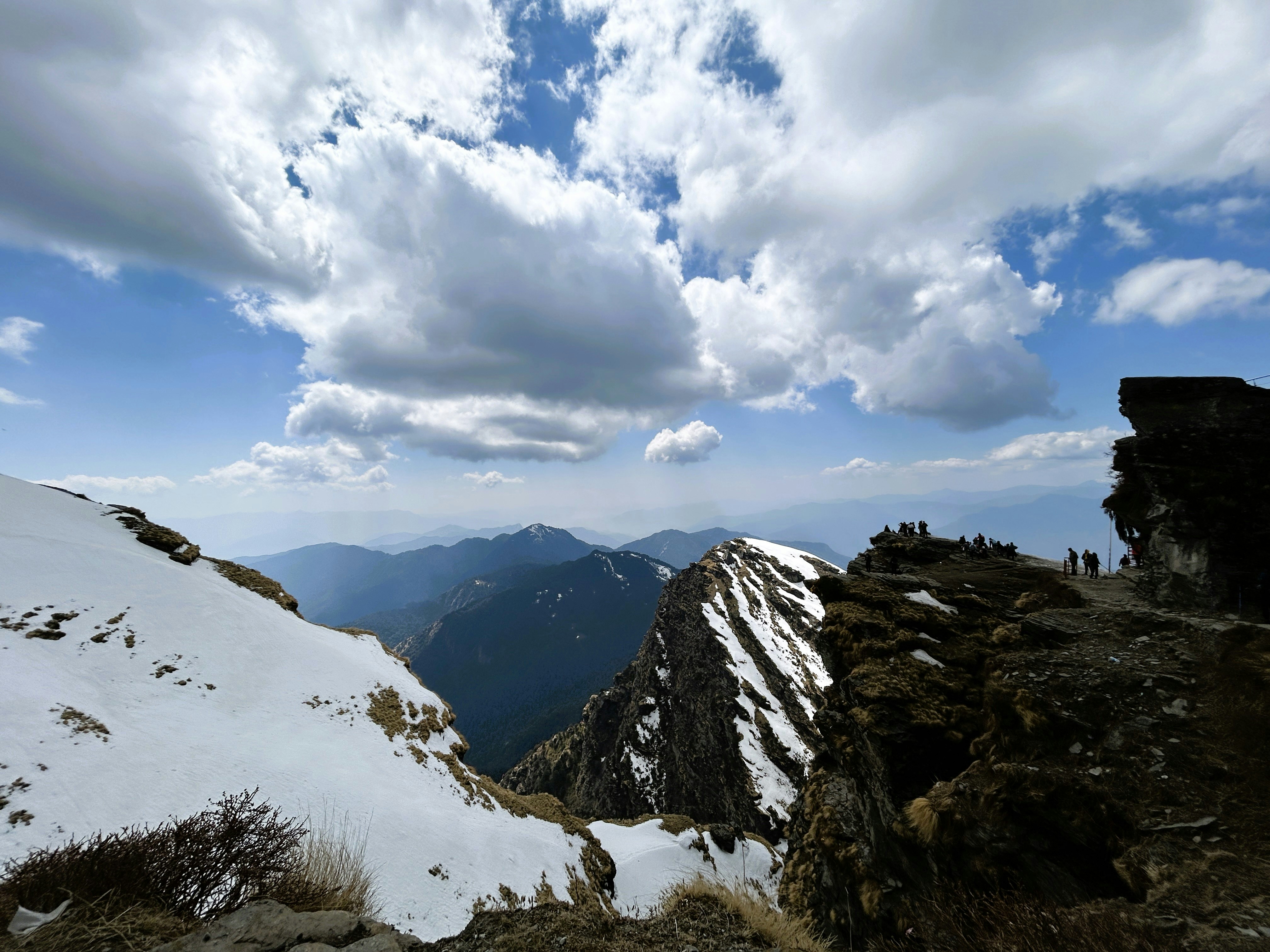 A snow covered mountain with a sky filled with clouds